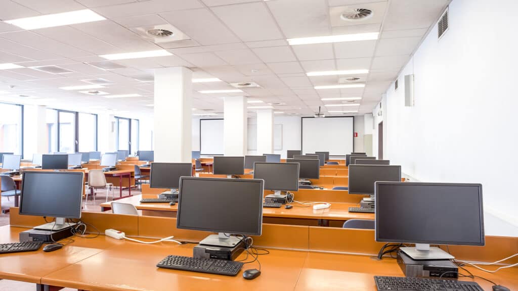 Professional call center environment with agents working at individual workstations, wearing headsets and engaged in customer service operations, showcasing a modern BPO office layout.
